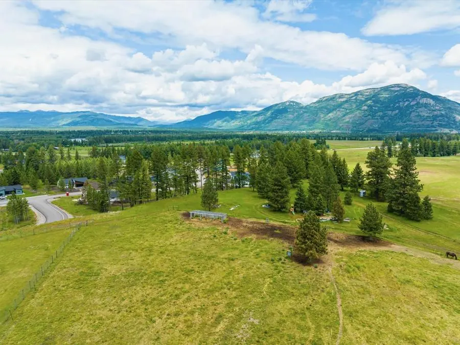 The open two-acre Glacier Adventure Field running back toward the range.