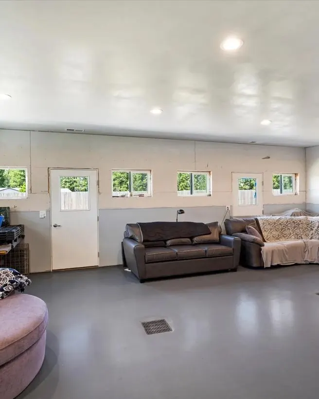 A bright, climate-controlled indoor room at the ranch where dogs rest in the evening.