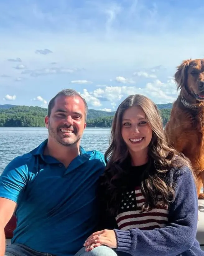 Matthew, his fianc&eacute;e Rachel, and their dog out on the lake.